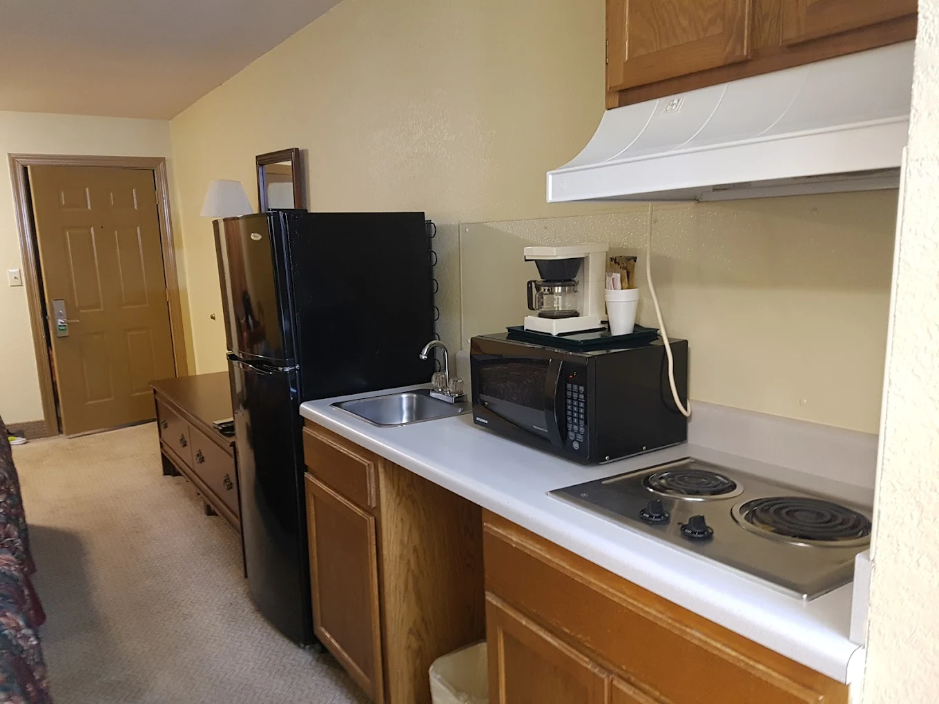 Kitchenette with stove, microwave, sink, and refrigerator